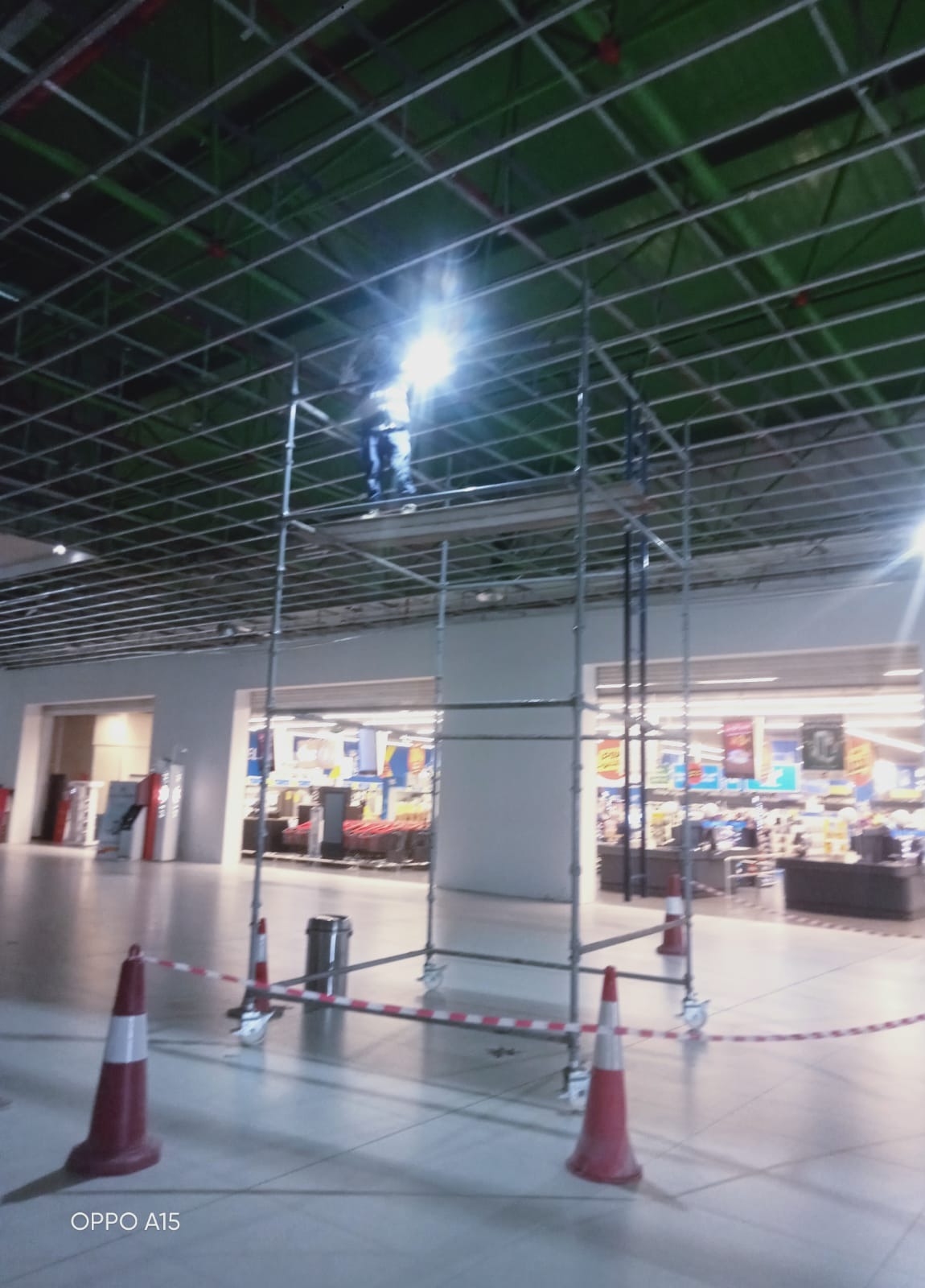 Scaffolding erection work with a secured access area inside a commercial retail facility