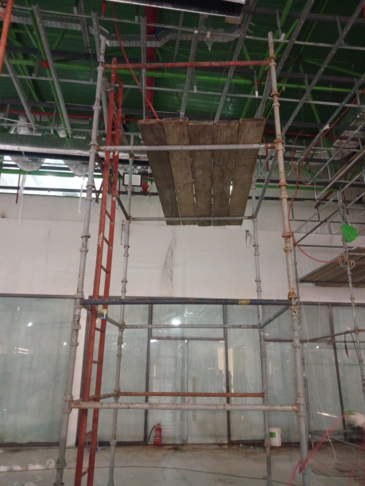 Scaffolding erection inside a retail shop in a shopping mall during maintenance works