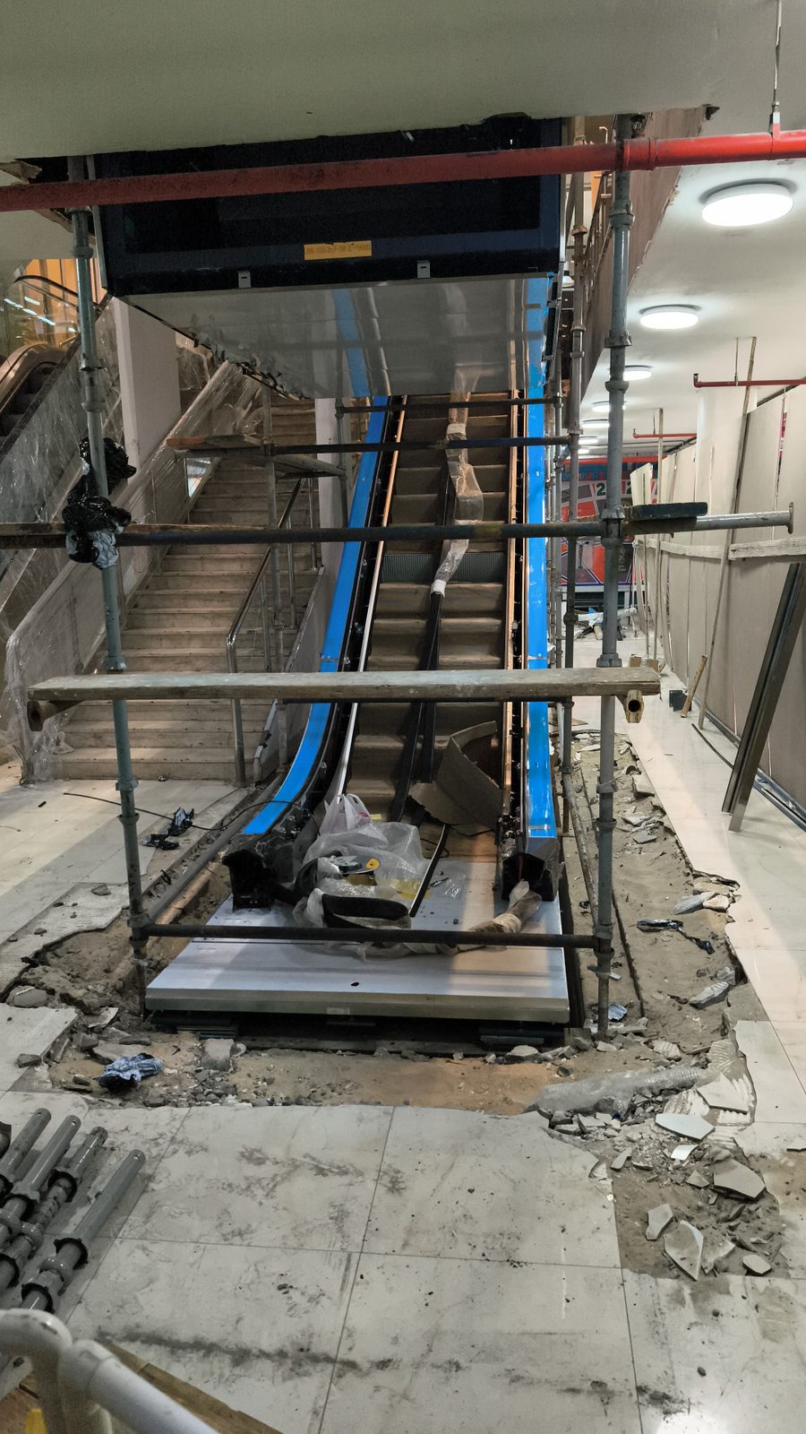 Scaffolding access structure erected around an indoor escalator for maintenance work