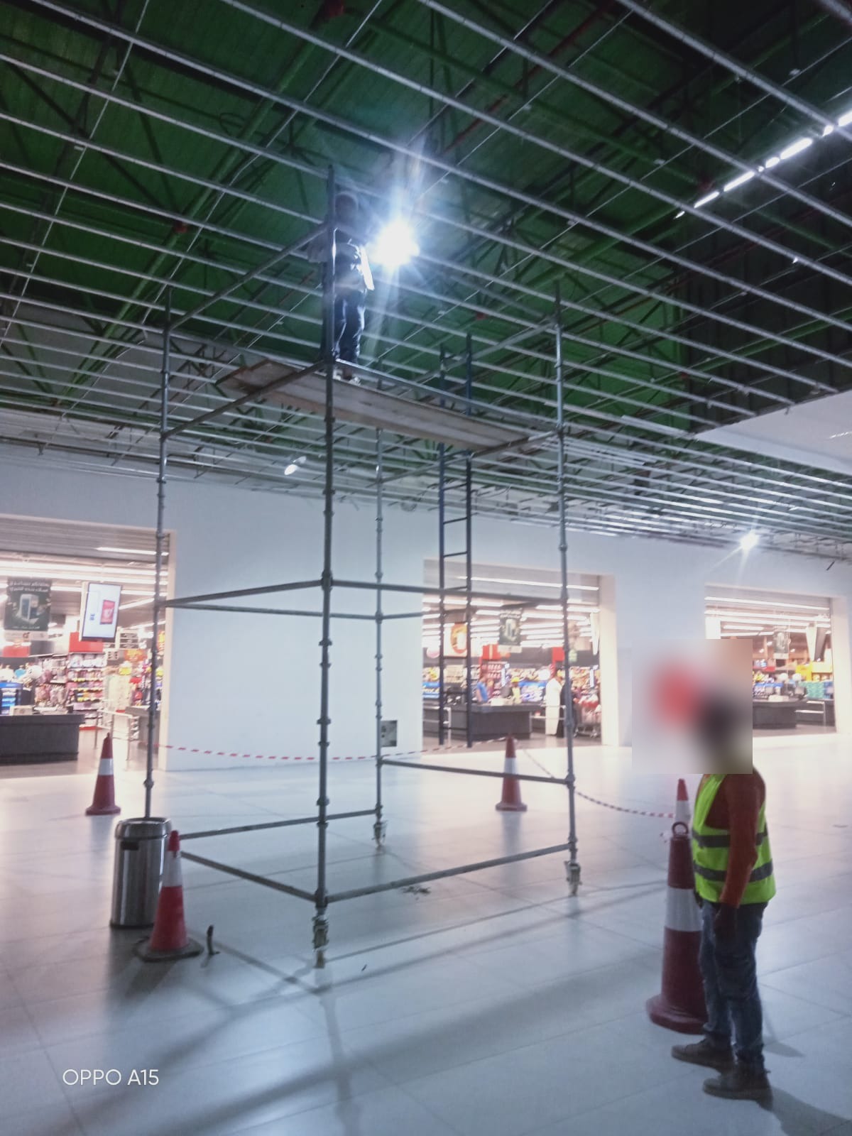 Scaffolding tower installation for overhead access at a commercial retail facility